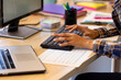 © Wavebreak Media - Midsection of biracial casual businesswoman working on computer at desk in office