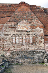 Old brick wall shows an outline of a previous adjacent building.