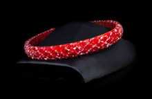 Hair diadem on black background. Red bracelet close-up beautiful view for shop display
