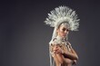 Sensuous woman in majestic pearl carnival costume in studio