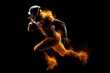 © surassawadee - Silhouette of American football player, player in action on fire. Isolated on black background