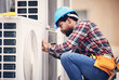 © Jordan C/peopleimages.com - Black man, electrician and maintenance on air conditioner with engineering and handyman working with tools on roof. AC repair, professional male technician outdoor and power generator with service