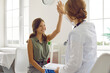 © Studio Romantic - Cheerful preteen girl gives high five to female doctor celebrating successful completion of treatment. Happy smiling Caucasian child in doctor's office together with woman in medical gown.