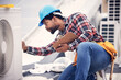 © Jordan C/peopleimages.com - Technician, clipboard or air conditioning inspection on rooftop for safety, power or maintenance. Electrician, black man or paperwork on hvac system, ac repair or quality assurance for sustainability