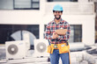 © Jordan C/peopleimages.com - Engineering, portrait and man on clipboard for air conditioner maintenance, inspection or technician ac repair. Happy African person, handyman or electrician, electrical checklist and rooftop service