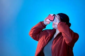 Poster - Vr gaming or woman in metaverse studio for future innovation, cyber or 3d on blue background. Futuristic media mockup, technology software or girl gamer with digital virtual reality glasses online
