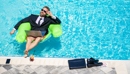 man trader work and relax, copy space banner. man trader work and relax in swimming pool.