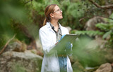 Fototapeta  - Clipboard, nature and scientist woman in agriculture research, sustainability and checklist of climate change test. Plants, sustainable growth and thinking, inspection or science person writing notes
