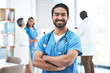 © Jordan C/peopleimages.com - Medical, arms crossed doctor with portrait of man for healthcare, surgery and happy. Smile, medicine and confident with male nurse standing in hospital for wellness, cardiology and expert