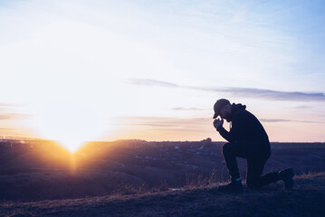 Prayer. A man prays on his knees. Repentance for sins. Kneeling