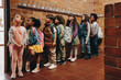 © Jacob Lund - Primary school students waiting in line outside their classroom. Children waiting to start class in the morning