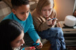 © Johnér - Children playing video games at home