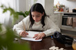 © Johnér - Girl doing homework at dining table