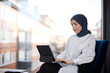 © Johnér - Businesswoman in hijab using digital tablet in office