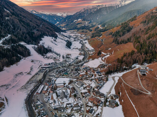 Wall Mural - Cloudy valley if the Alpine village and the ski resort in Tyrol, Italy. Concept of the ski resort in Alps.