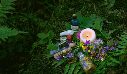 Wall Mural - Candle, witch bottles, crystals and flowers on dark forest natural background. Witchcraft, magic spiritual practice. pagan, Wiccan, Slavic traditions. esoteric ritual for Midsummer, Litha sabbath