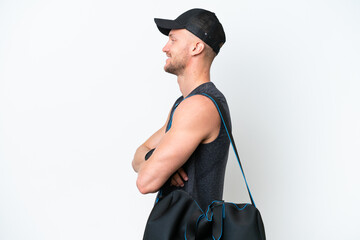 Wall Mural - Young blonde sport caucasian man with sport bag over isolated white background in lateral position