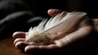 © Marcus Jacobi - one hand holds a feather, generativ AI