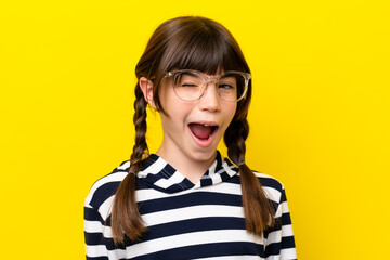 Wall Mural - Little caucasian girl isolated on yellow background With glasses and happy expression