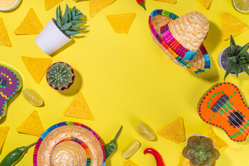 Wall Mural - Mexican Cinco de Mayo holiday background with mexican cactus, nachos chips, guitars, sombrero hat and chilli pepper, Bright yellow flat lay with traditional Cinco de Mayo decor and party accessories