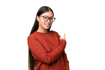 Wall Mural - Young Asian woman over isolated background pointing to the side to present a product