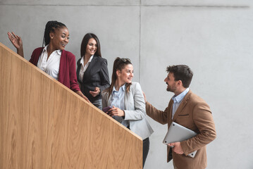 Group of happy business people walking in office building. Colleagues talking strategy, ideas for business advance and prosperity of company research in the future. Planning and investing