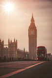 Fototapeta Londyn - Red London Bus on the Westminster Bridge and Big Ben Tower in the background.
