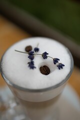 Poster - a white cup topped with liquid and coffee beans and flowers