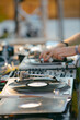 © ADDICTIVE STOCK - Cropped unrecognizable DJ mixing music on console