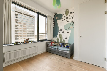 a kid's room with a wall mural on the wall and wooden flooring in front of the window