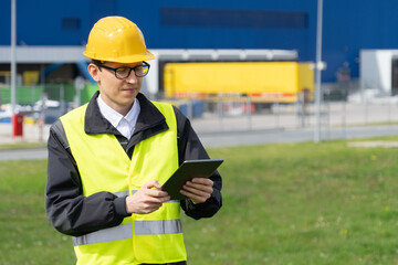 Poster - Logistician with digital tablet on a background of logistic center