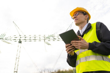 Poster - Engineer with digital tablet on a background of power line tower