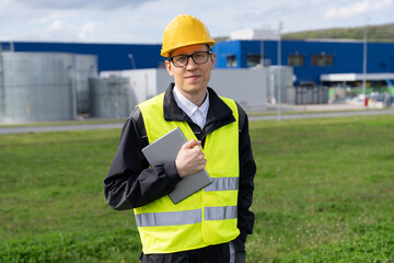 Poster - Engineer with digital tablet on a background of modern smart factory. Digital transformation and industry 4.0	