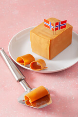 Sticker - Norwegian brunost traditional brown cheese block and slicer