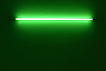 Green Neon Light Bulb On White Wall.