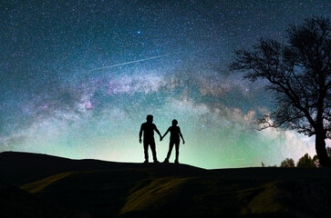 fantasy landscape, couple lovers silhouette standing on the hill, on the milky way galaxy background
