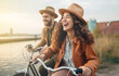 © bluebeat76 - Happy mature people couple enjoy outdoor leisure activity riding bicycle. Laughing out loud in friendship and relationship . AI generative