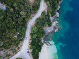 Fototapeta Na ścianę - overhead view of car moving by road next to sea shore