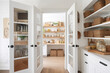 © Trinette Reed - Organized food pantry closet in cozy cottage style home