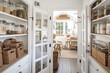 © Trinette Reed - Organized food pantry with baskets closet in cozy cottage style home