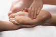 Masseur doing foot massage with oil in spa salon. Spa procedures. Body care concept. Close-up view