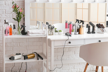 Poster - Different hair sprays and accessories on table in beauty salon