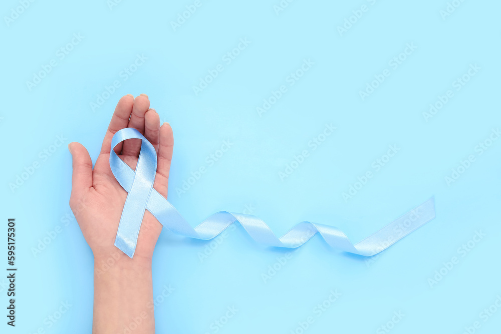 Woman with awareness ribbon on blue background. Diabetes concept