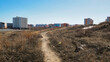 View of the city of Ust-Kamenogorsk (kazkahstan). New residential area. Spring. Urban cityscape landscape. Mountain path