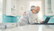 © Azeemud/peopleimages.com - Elderly couple, laptop and video call in kitchen, web browsing or social media in house. Computer, retirement and happy man and woman on videocall, online chat and virtual communication together.