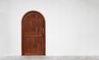 Classic arched wooden door on white wall.
