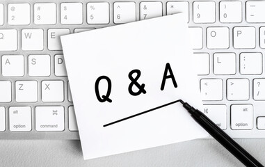 Poster - White paper with text Q and A lying on the keyboard