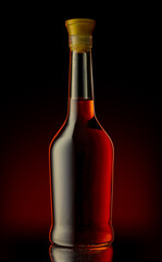 Wall Mural - Bottle of unopened premium alcohol, brandy, or cognac on a black background. Ideal for a mock-up design.