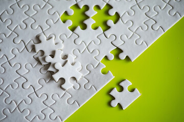 Wall Mural - Clean puzzle elements on the background. Empty puzzle piece on the table. Teamwork concept.