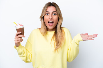 Canvas Print - Young Uruguayan woman holding Frappuccino isolated on white background with shocked facial expression